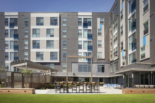 Lush courtyard with seating and landscaping at One Beachmont Apartments