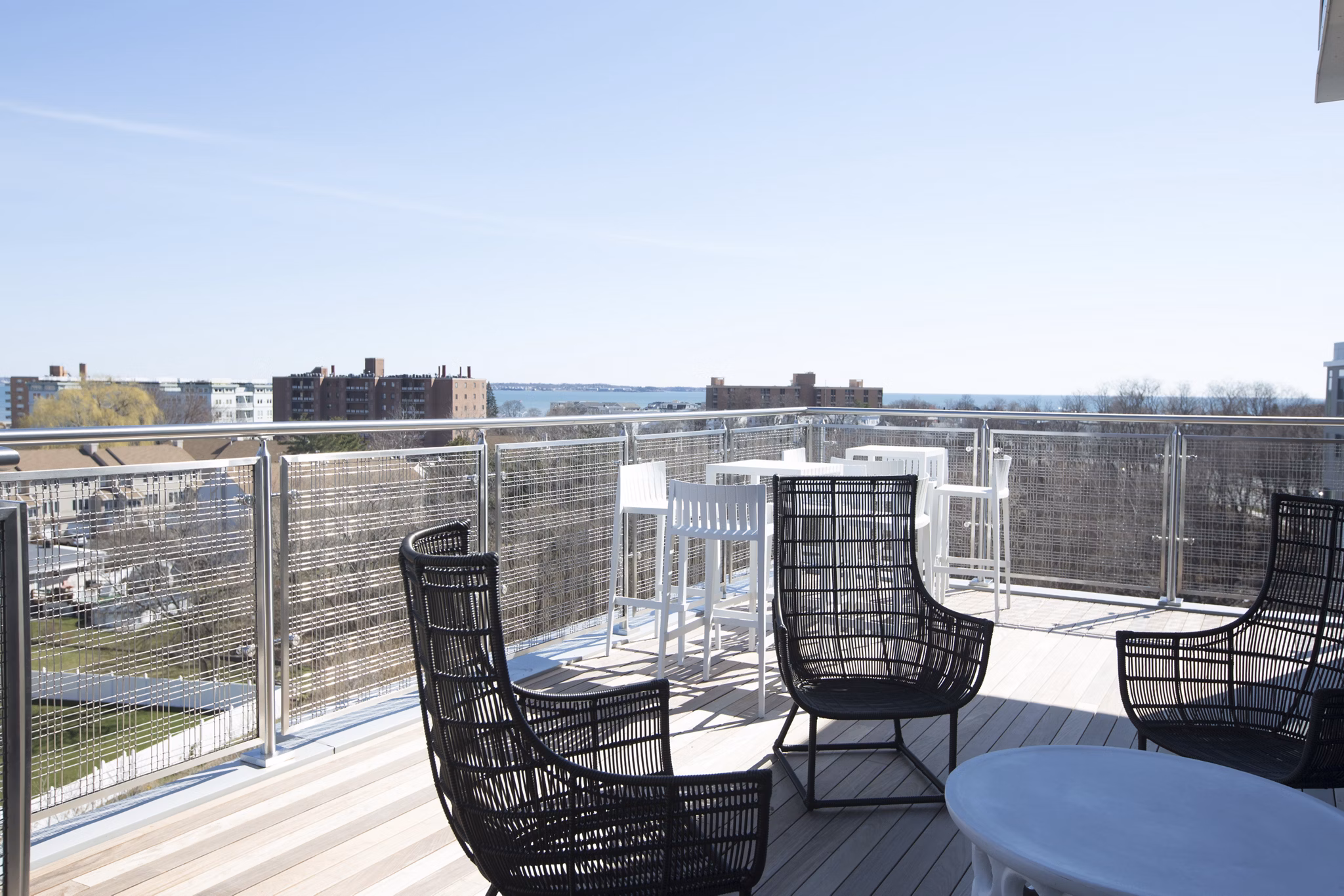 Expansive rooftop deck with seating and city views at One Beachmont Apartments