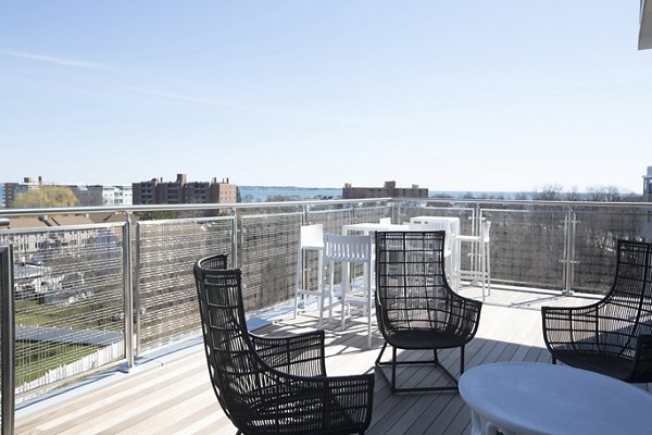 Expansive rooftop deck with seating and city views at One Beachmont Apartments