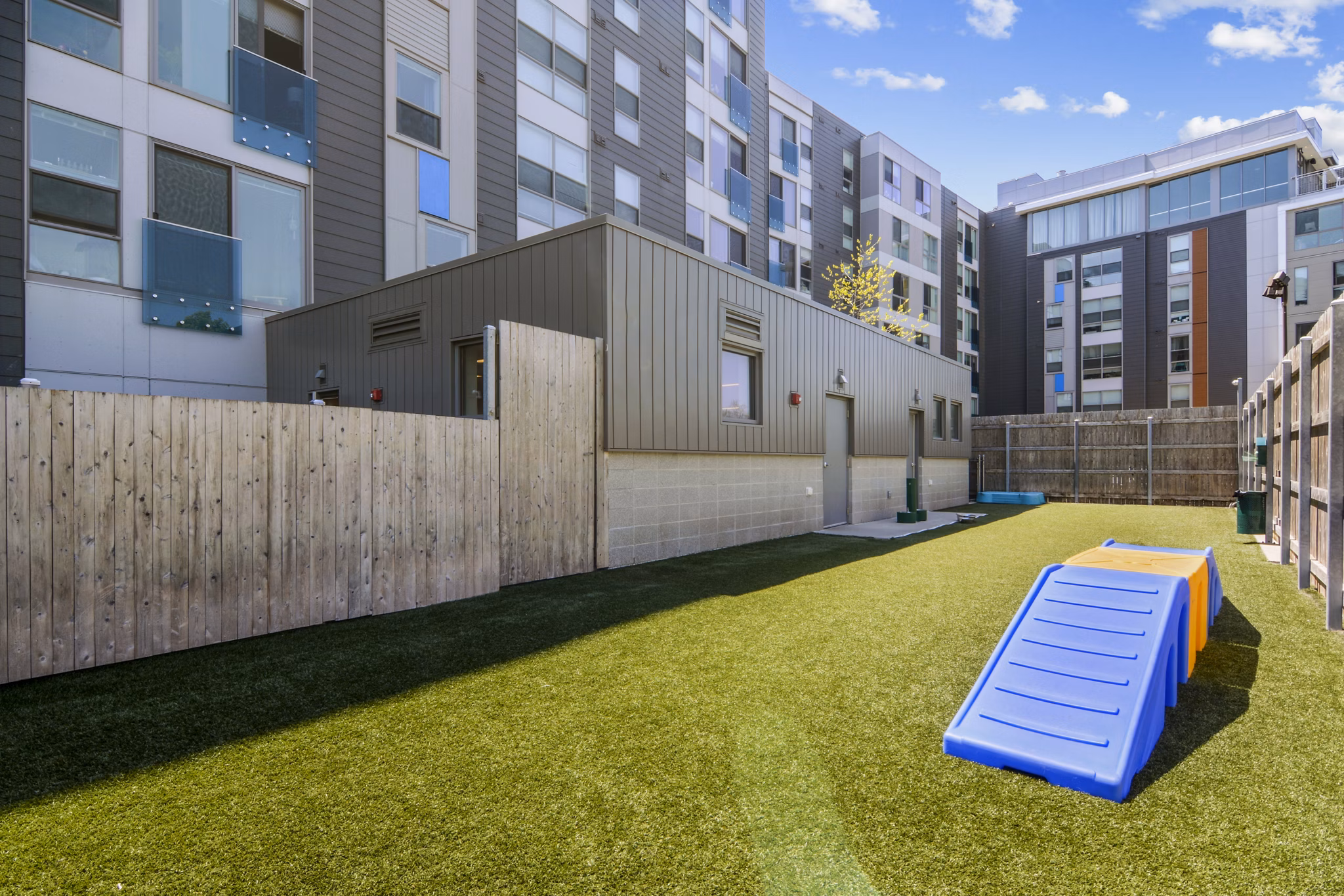 Dog park with agility equipment at One Beachmont Apartments for resident pets