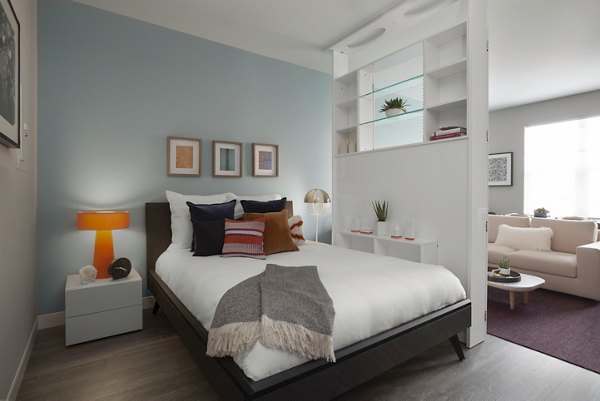 Andi Apartments: Modern bedroom with sleek decor and ample natural light