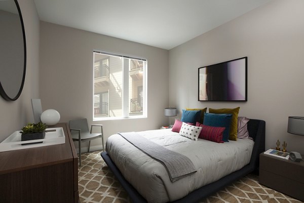 Modern bedroom with stylish decor at The Andi Apartments, luxury Greystar property in vibrant Boston neighborhood