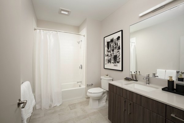 Modern bathroom with glass shower and sleek fixtures at The Andi Apartments