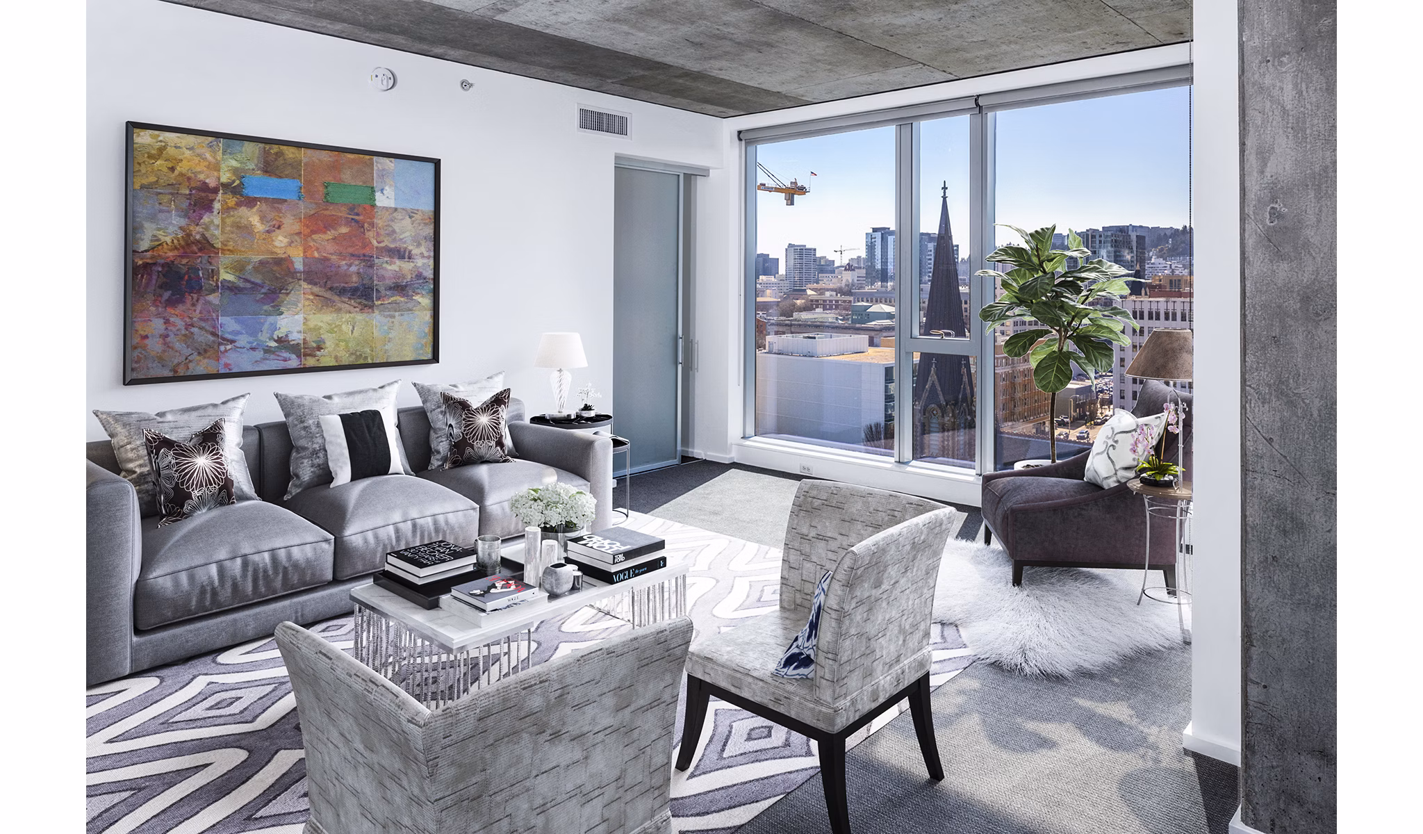 Cozy living room with modern decor and ample natural light at Indigo at Twelve West Apartments