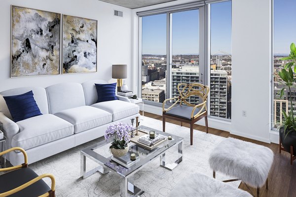 Contemporary living room with sleek furniture and large windows at Indigo at Twelve West Apartments