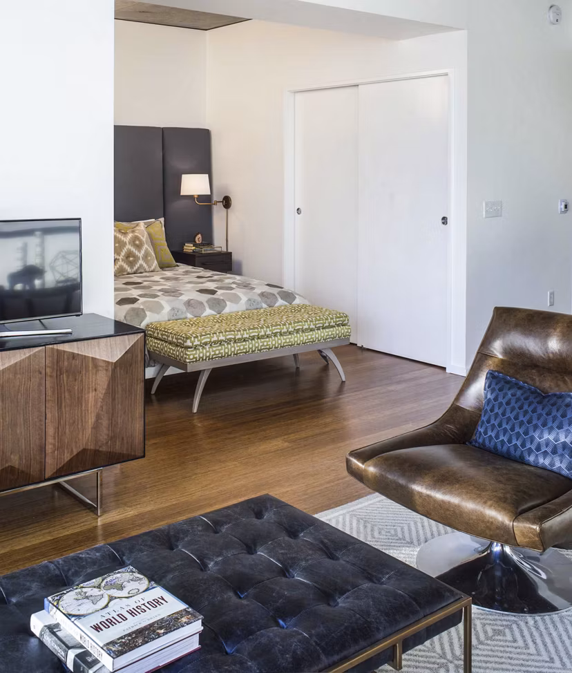Modern living room with sleek furnishings at Indigo at Twelve West Apartments