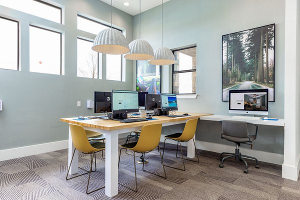 Business center with workstations and office chairs at Domain at Town Centre Apartments designed for productivity and comfort