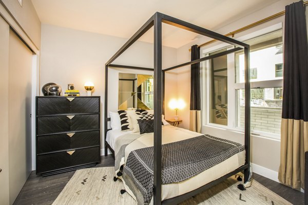 Modern bedroom with sleek decor at Fourth Street East Apartments