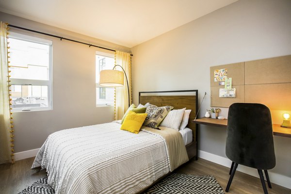 Cozy bedroom with modern decor at Fourth Street East Apartments, offering a luxurious living experience in the heart of the city