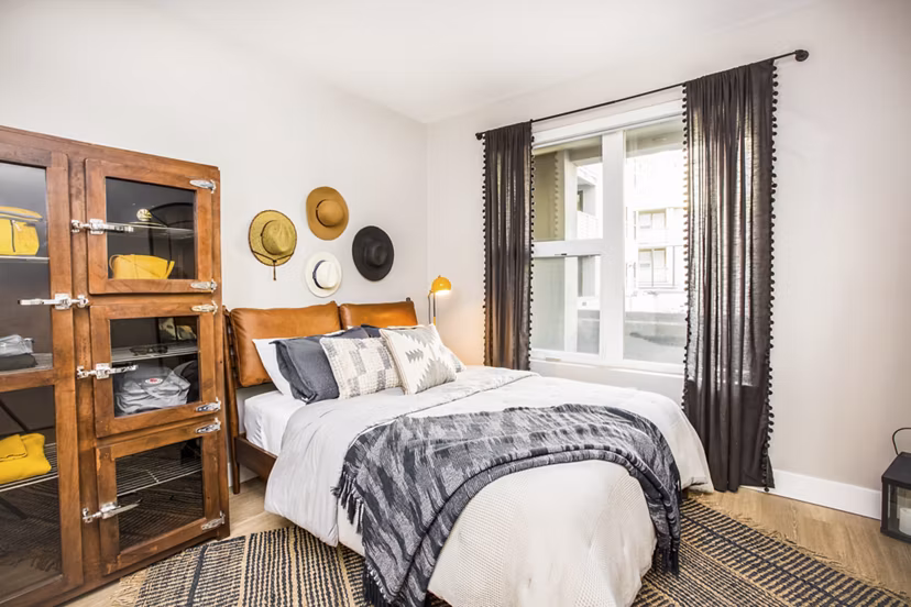 Bedroom featuring modern design and plush bedding at Fourth Street East Apartments