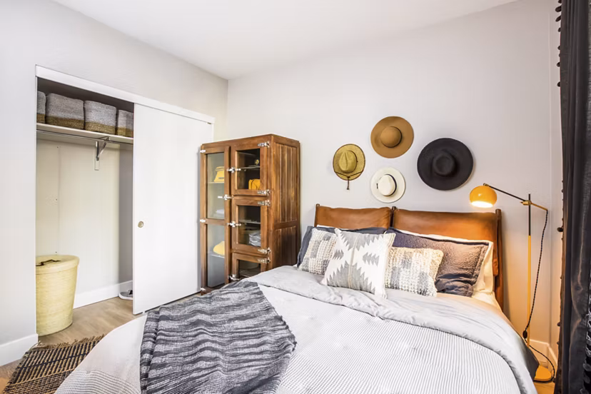 Bedroom featuring elegant decor and ample natural light at Fourth Street East Apartments