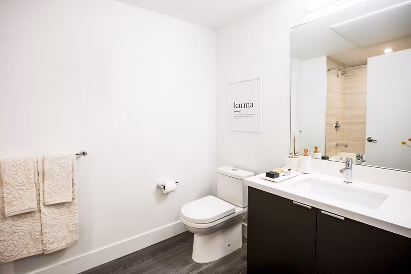 Luxurious bathroom with modern fixtures at Fourth Street East Apartments, featuring elegant marble countertops and sleek design elements