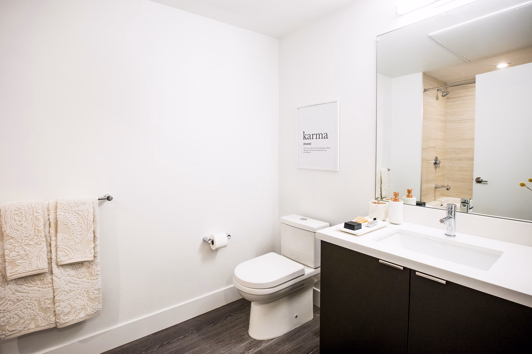 Luxurious bathroom with modern fixtures at Fourth Street East Apartments, featuring elegant marble countertops and sleek design elements