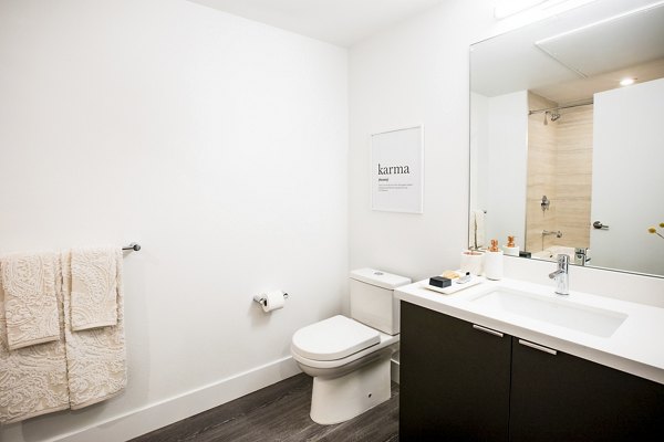 Luxurious bathroom with modern fixtures at Fourth Street East Apartments, featuring elegant marble countertops and sleek design elements