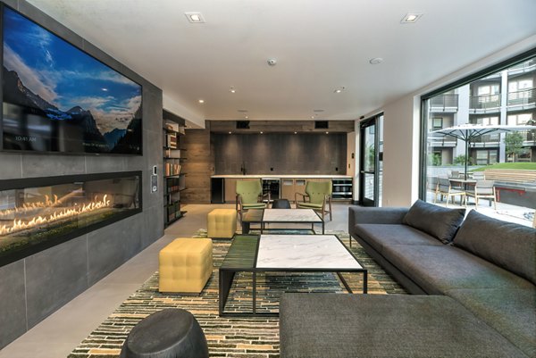 Fourth Street East Apartments: Stylish clubhouse featuring contemporary decor and ample seating