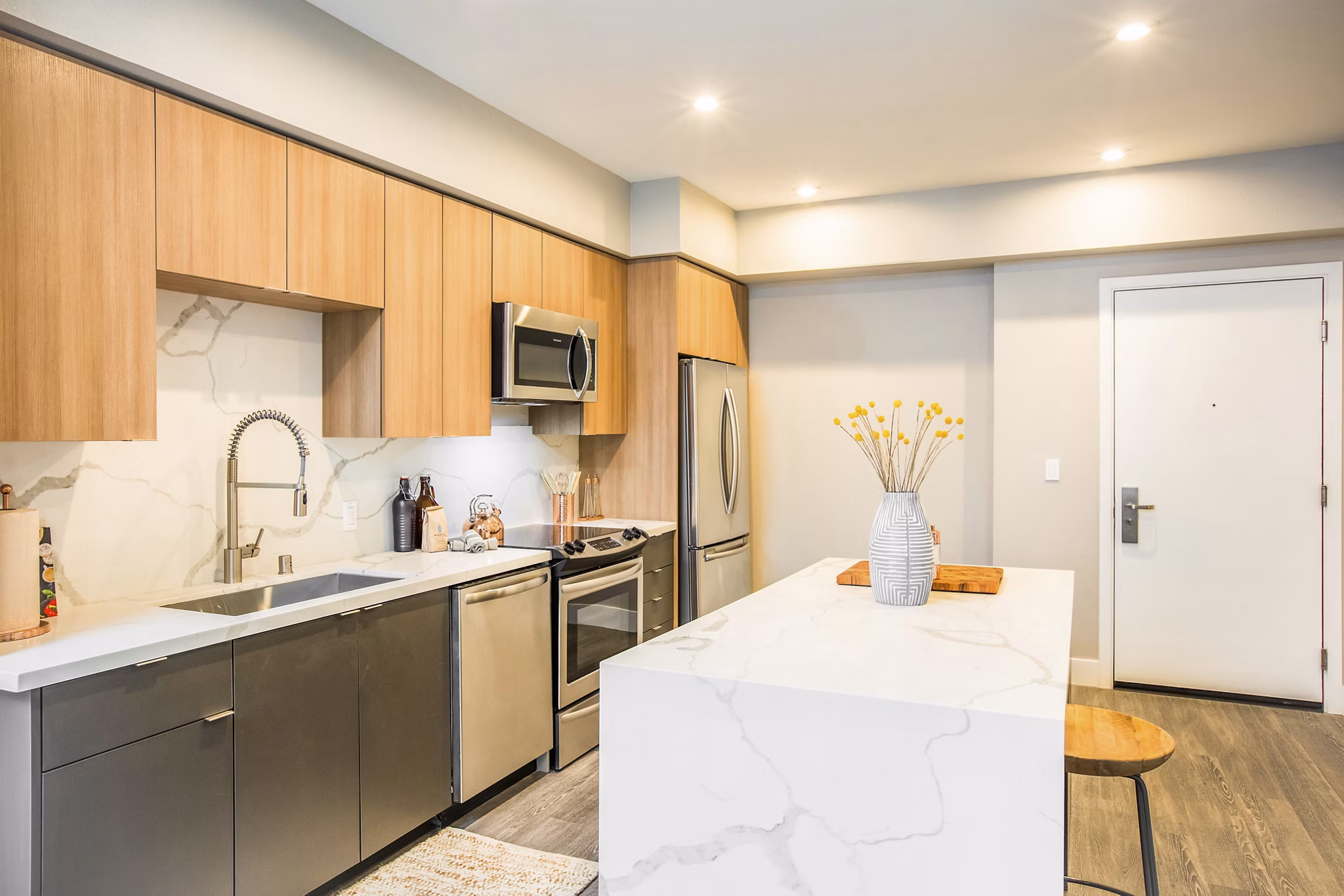 Kitchen featuring sleek countertops and modern cabinetry in Fourth Street East Apartments