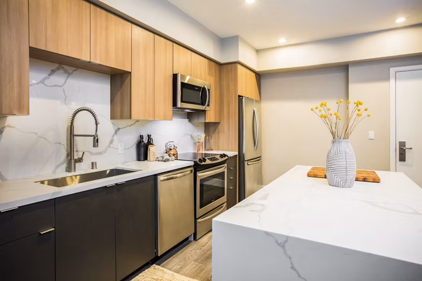 Modern kitchen with sleek countertops and stainless steel appliances at Fourth Street East Apartments