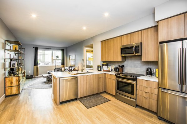 Modern kitchen with sleek cabinetry and stainless steel appliances at Fourth Street East Apartments