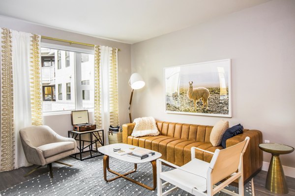 Stylish living room with modern decor and natural light at Fourth Street East Luxury Apartments