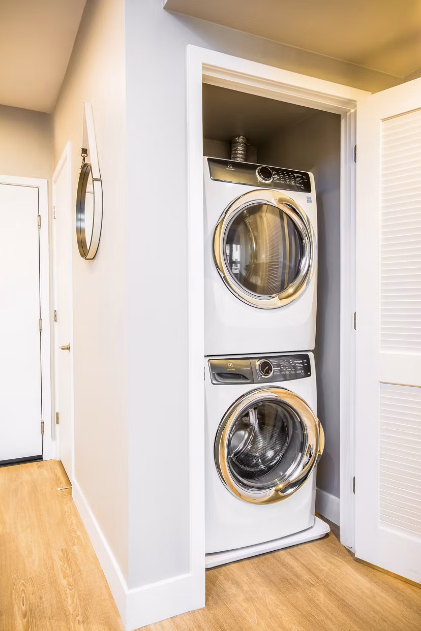 Modern laundry room with high-efficiency washers and dryers at Fourth Street East Apartments
