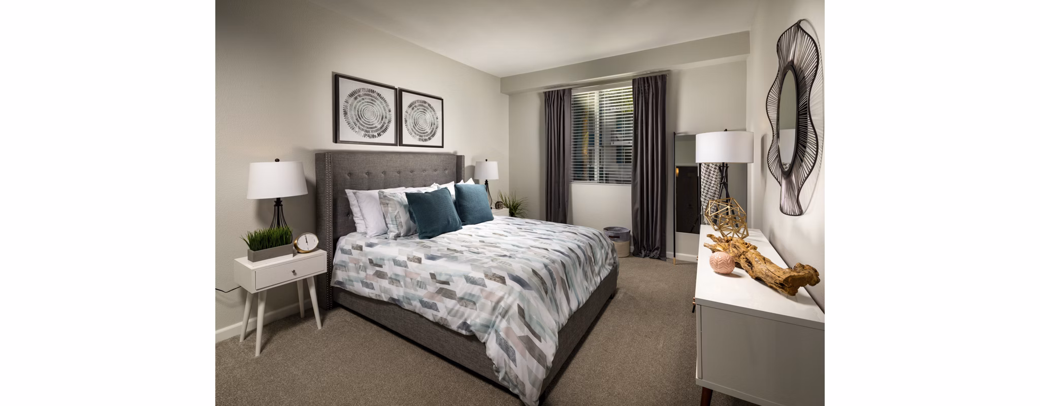 Cozy bedroom with modern decor at The District Apartments