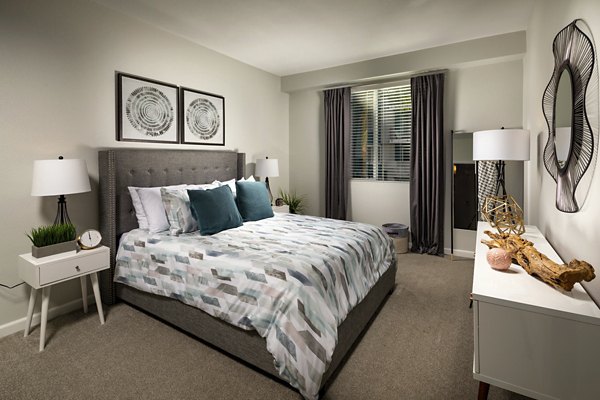 Cozy bedroom with modern decor at The District Apartments