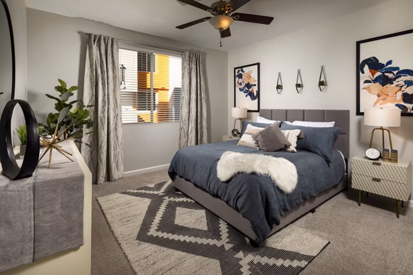 The District Apartments: Cozy bedroom with modern furnishings at Greystar luxury apartments