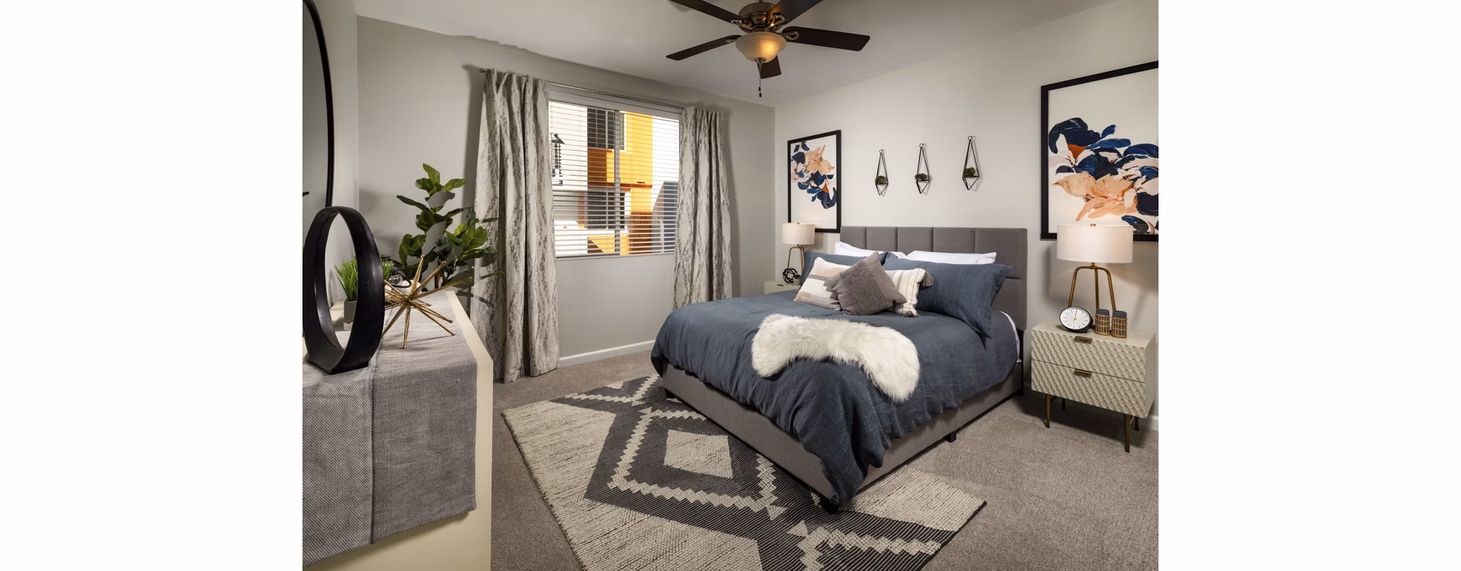 The District Apartments: Cozy bedroom with modern furnishings at Greystar luxury apartments