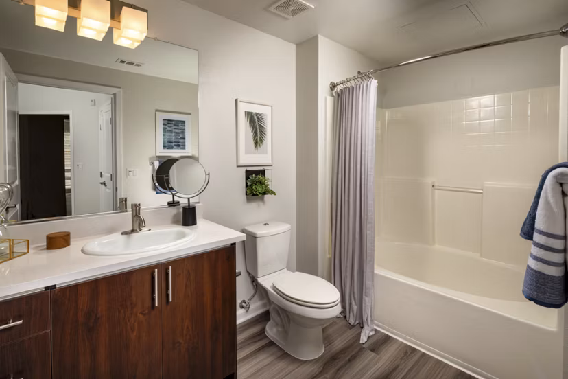 Bathroom featuring elegant marble countertops and luxury fixtures at The District Apartments