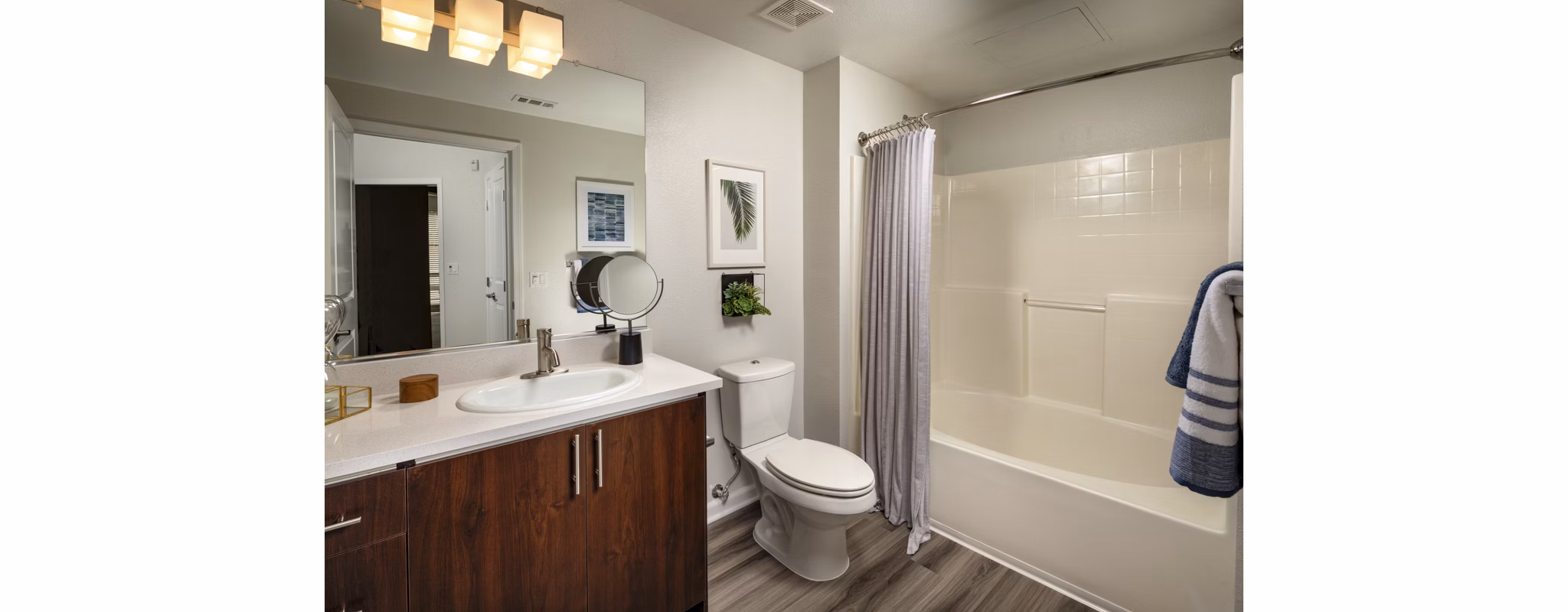 Bathroom featuring elegant marble countertops and luxury fixtures at The District Apartments