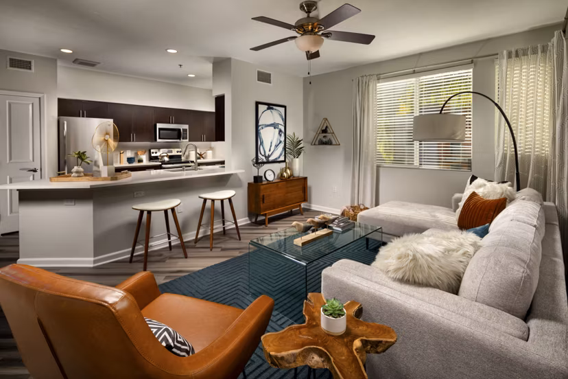 Spacious living room with modern decor at The District Apartments
