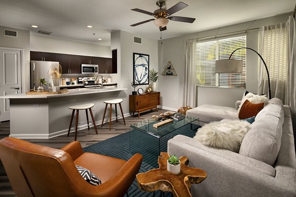 Spacious living room with modern decor at The District Apartments
