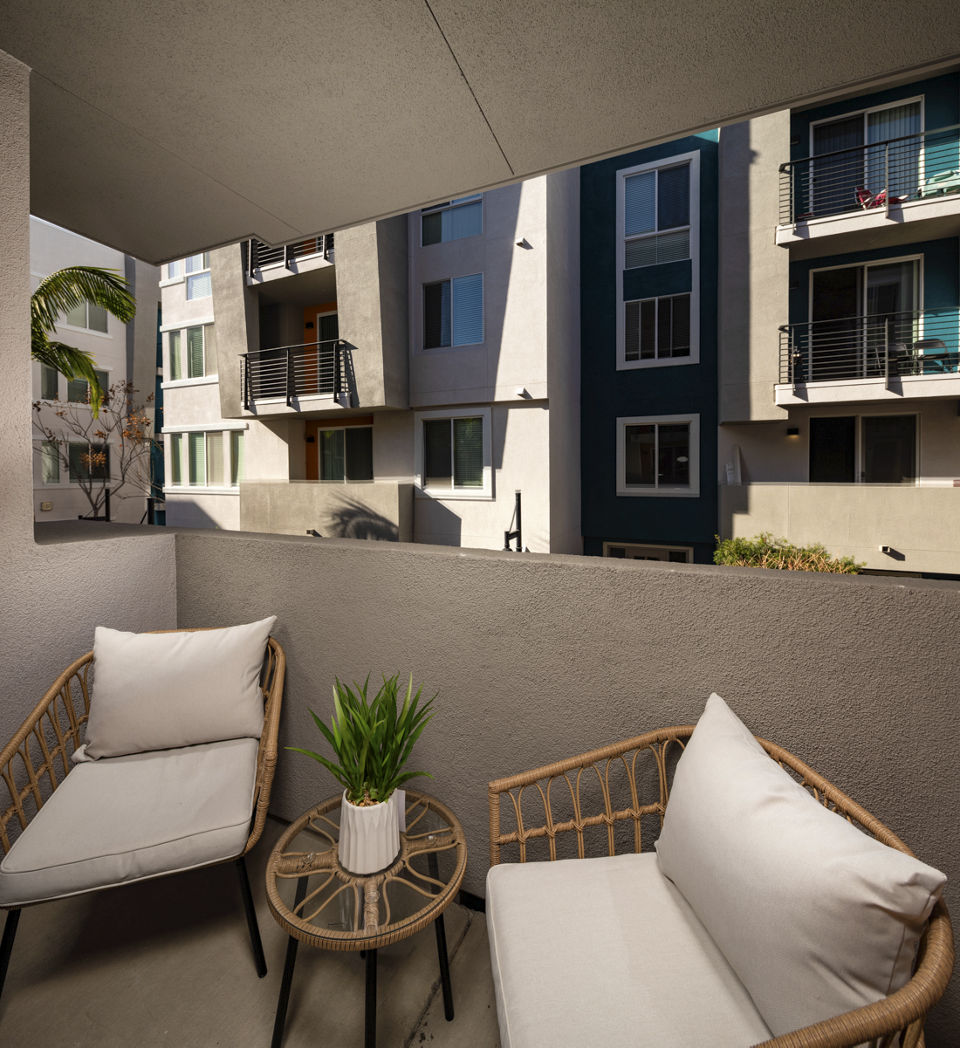 The District Apartments: Relaxing patio space with modern seating and lush greenery in a luxury setting