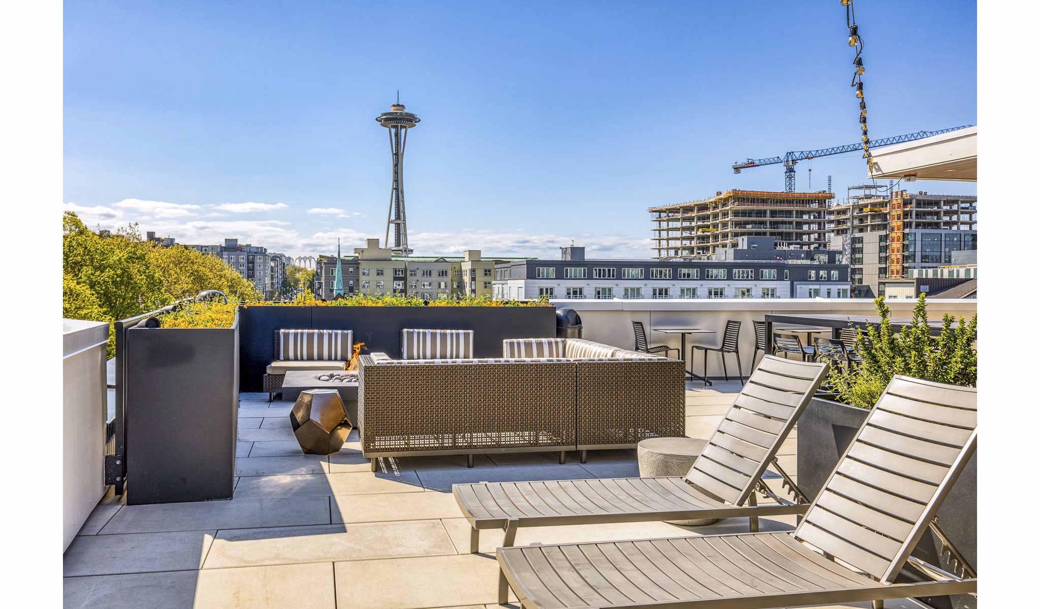 Luxurious rooftop lounge with city skyline views at Orion Apartments
