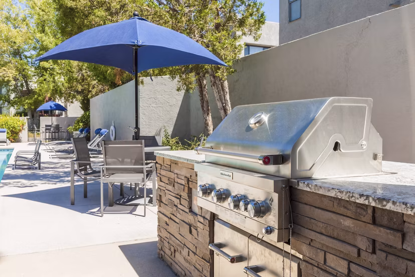 Outdoor BBQ grill area at The Village at Tierra Antigua Apartments offering community gathering space