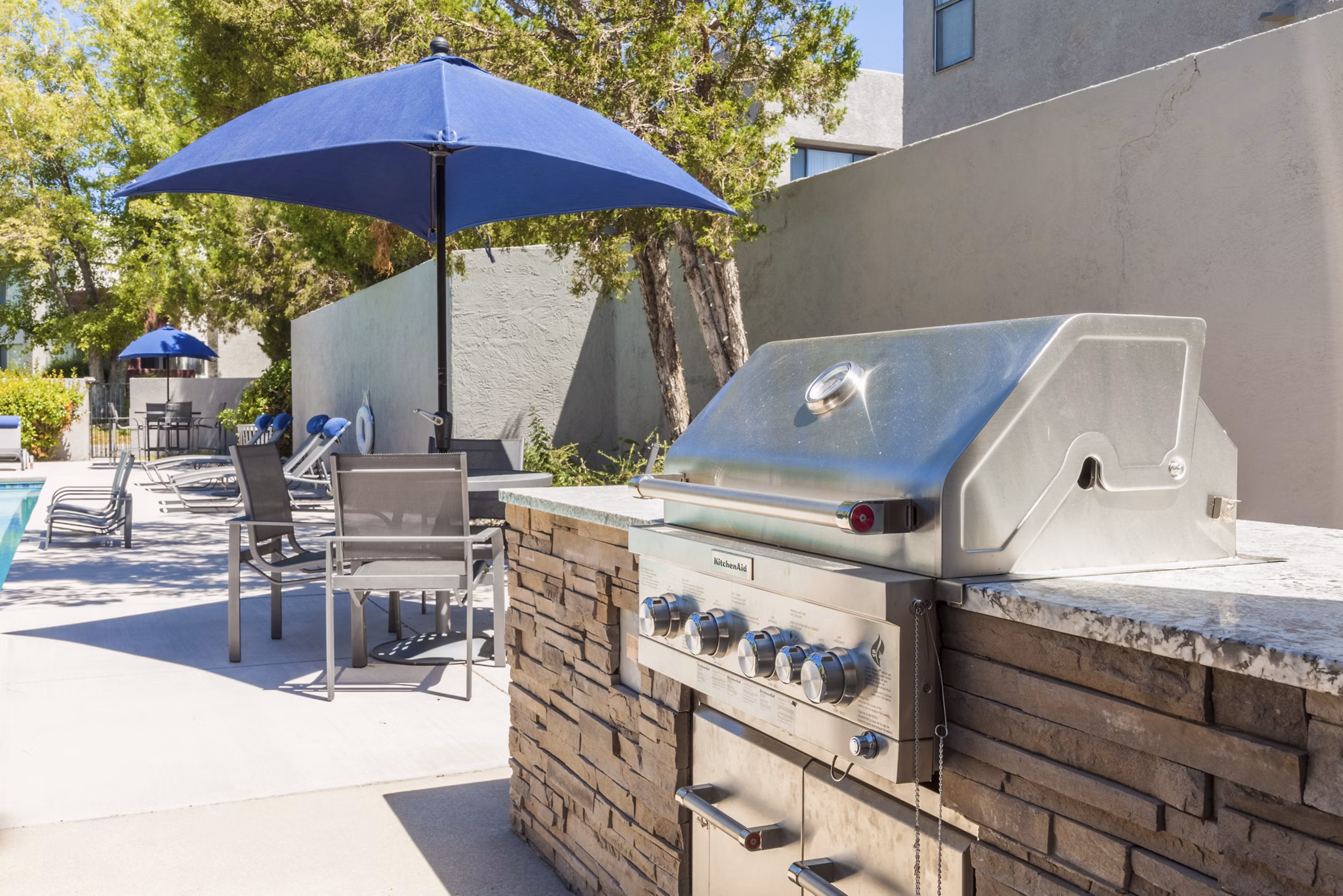 Outdoor BBQ grill area at The Village at Tierra Antigua Apartments offering community gathering space