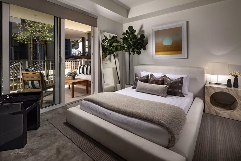 Modern bedroom with stylish decor at LA Plaza Village Apartments