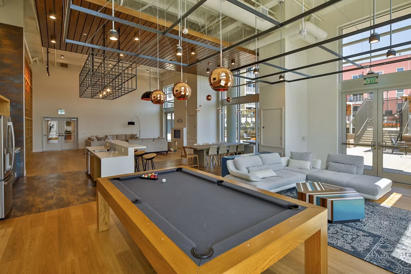 Clubhouse interior with modern furnishings at LA Plaza Village Apartments in Los Angeles, offering luxury living spaces