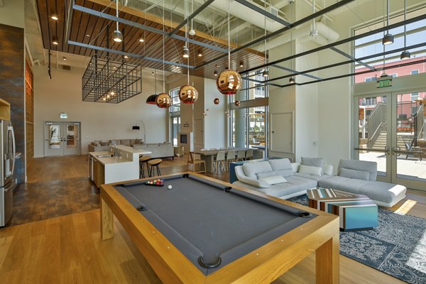 Clubhouse interior with modern furnishings at LA Plaza Village Apartments in Los Angeles, offering luxury living spaces