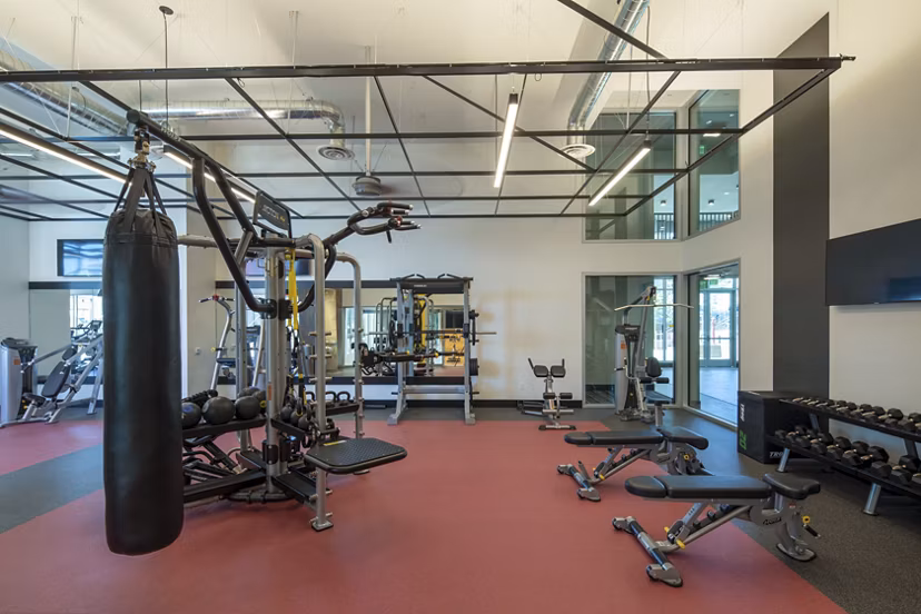 State-of-the-art fitness center at LA Plaza Village Apartments with modern equipment for residents