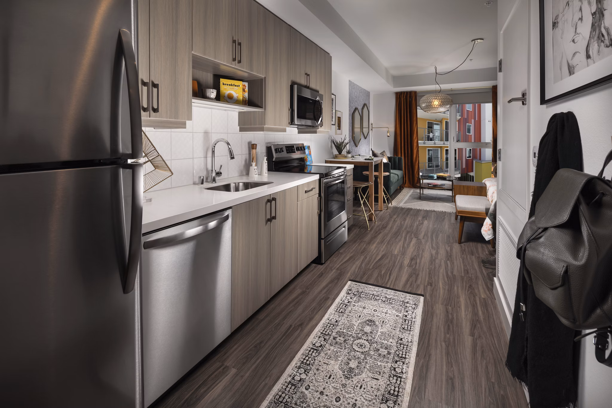 Modern kitchen with marble countertops and stainless steel appliances at LA Plaza Village Apartments