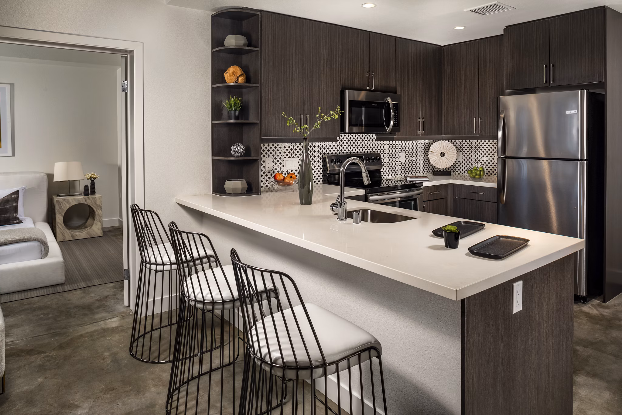 Well-appointed kitchen featuring modern appliances and sleek countertops at LA Plaza Village Apartments, a Greystar luxury community