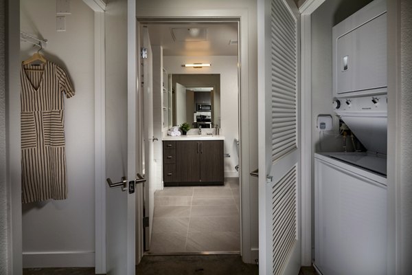 Laundry room with modern appliances at LA Plaza Village Apartments, luxury living in Los Angeles
