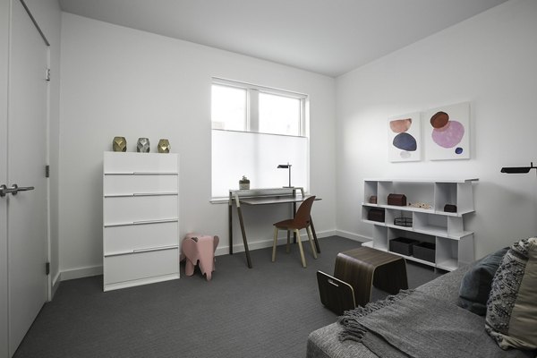 Bedroom with modern decor and soft lighting at Union House Apartments