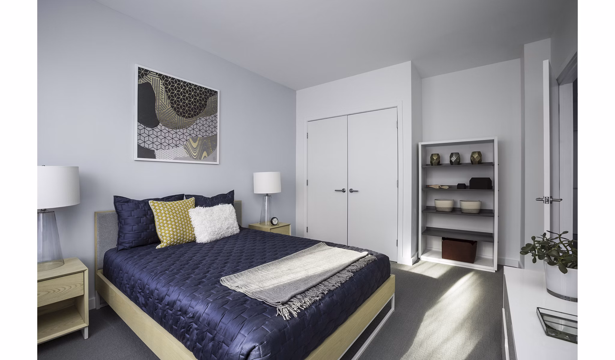 Modern bedroom with large windows at Union House Apartments, offering luxury living in a sleek design