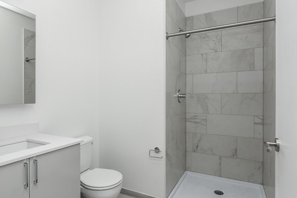 Modern bathroom with sleek fixtures and tile flooring at Union House Apartments