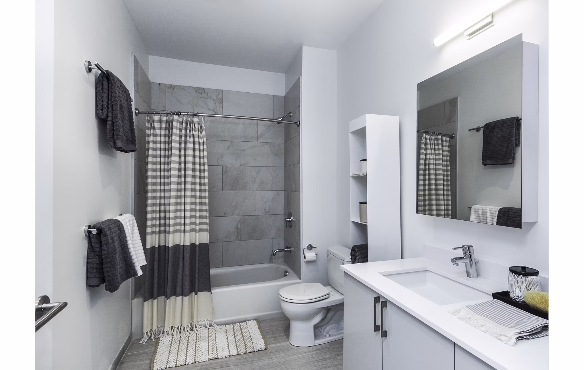 Modern bathroom featuring marble countertops and elegant fixtures at Union House Apartments