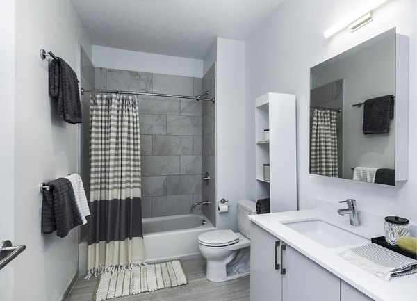 Modern bathroom featuring marble countertops and elegant fixtures at Union House Apartments