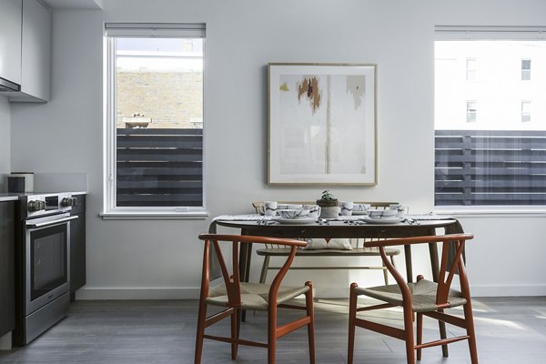 Dining room with modern furniture and stylish lighting at Union House Apartments