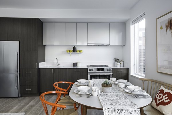 Contemporary kitchen with sleek countertops and stainless-steel appliances at Union House Apartments, a Greystar luxury property